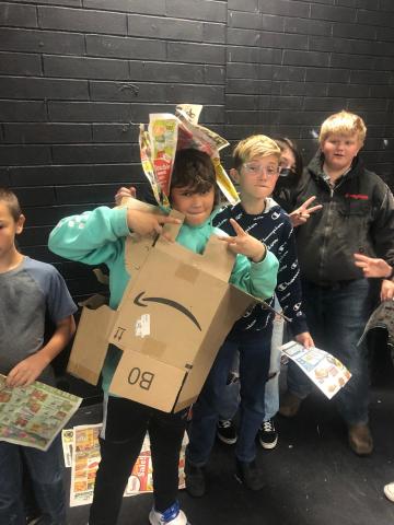 Students modeling recycled material costumes