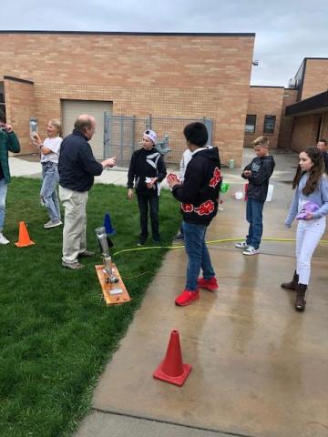 Students getting ready to launch egg parachutes